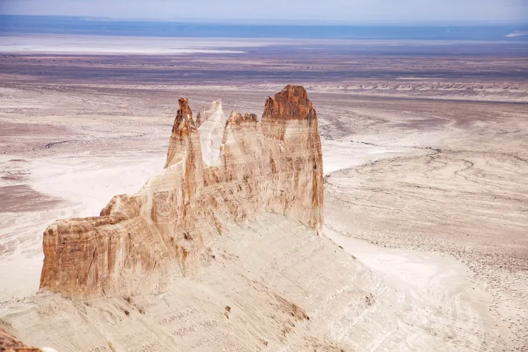Pale limestone pinnacles rising above the Bozzhyra plain