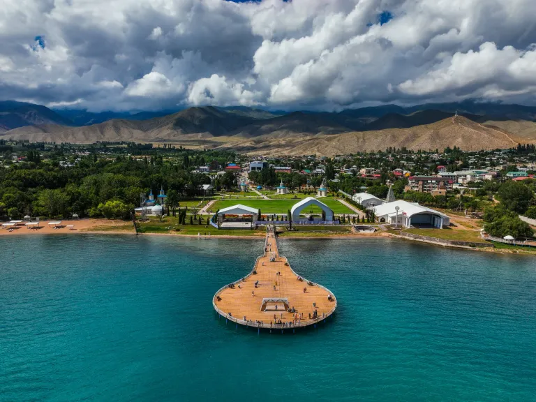 Aerial view of a round-ended pier and resort on Issyk-Kul