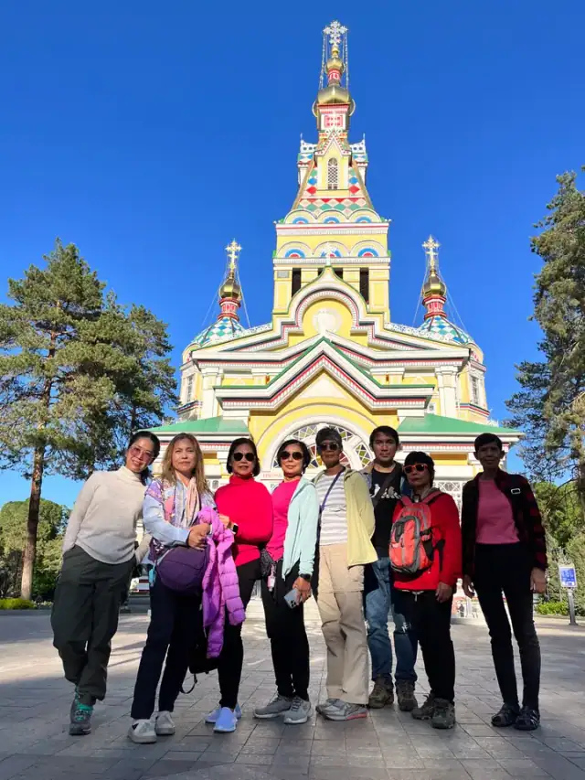 Visitors outside the colourful Ascension Cathedral in Almaty