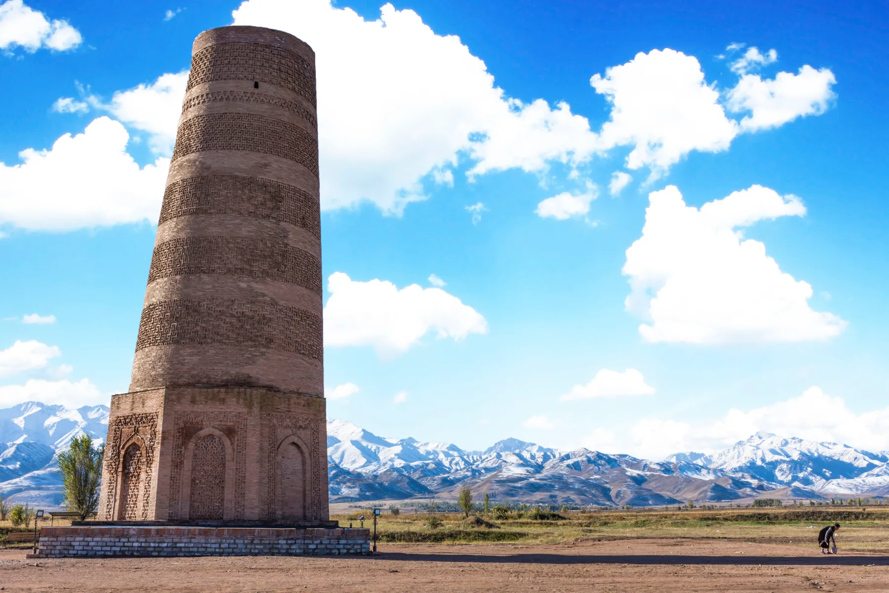 Burana Tower in Kyrgyzstan with mountains behind