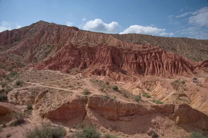 Red ridges and sandstone slopes inside Skazka Canyon