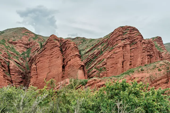 Red sandstone cliffs of Jeti-Oguz Gorge